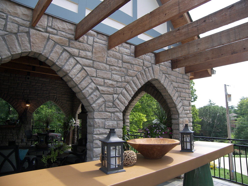 Medium sized traditional back veranda in Other with a pergola.