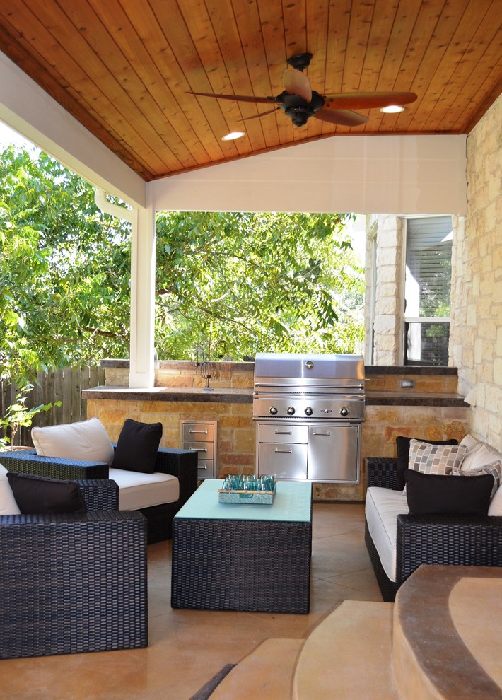 Medium sized classic back veranda in Austin with an outdoor kitchen, concrete slabs and a roof extension.