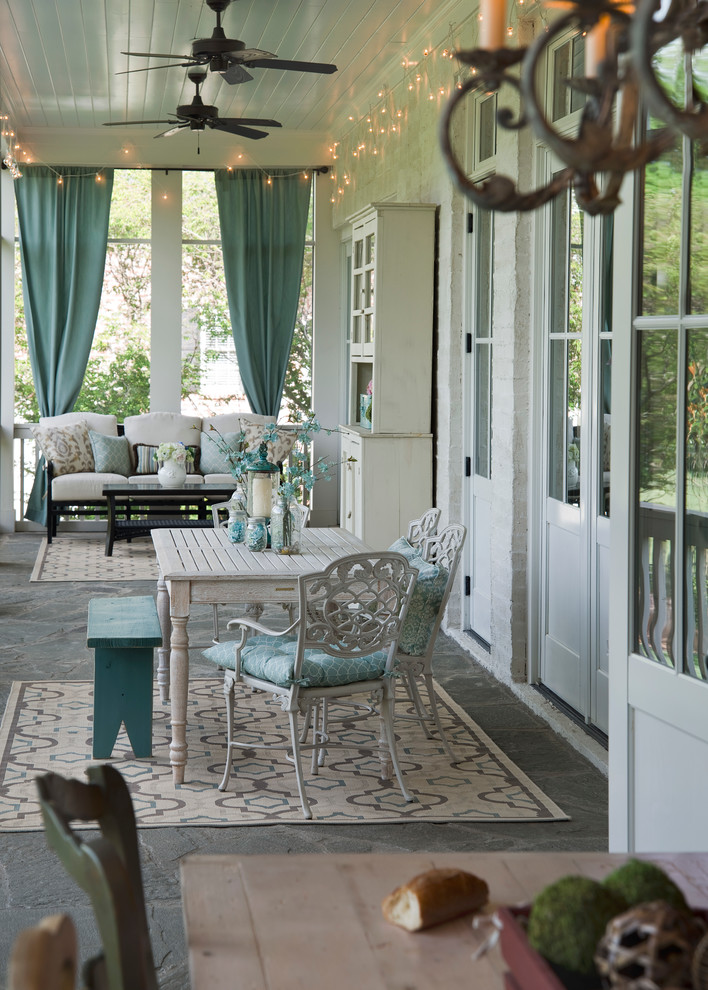 Inspiration for a mid-sized timeless stone screened-in front porch remodel in Nashville with a roof extension