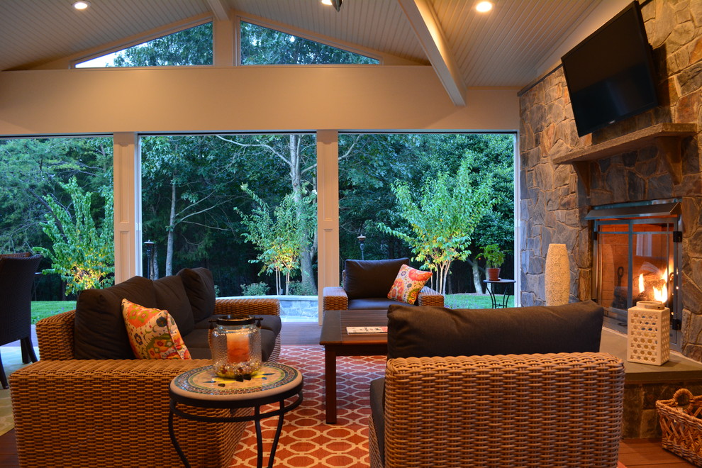 Inspiration for a mid-sized timeless screened-in back porch remodel in DC Metro with decking and a roof extension