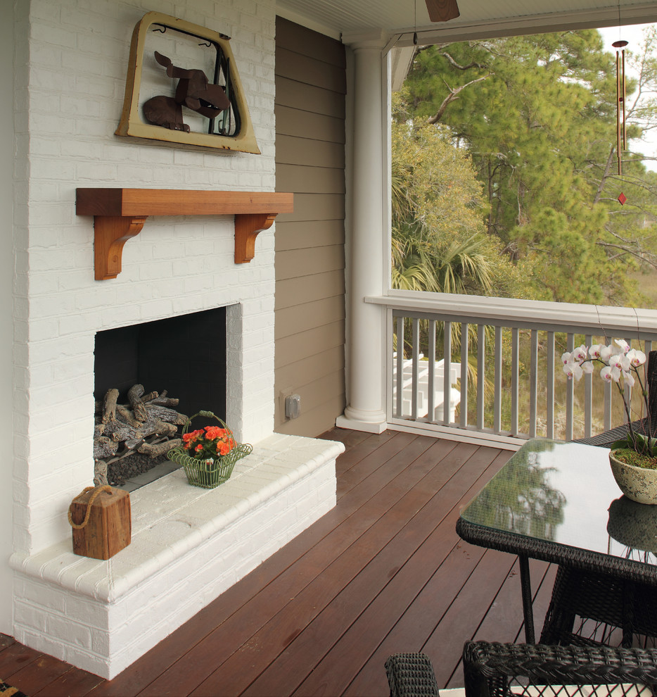 Design ideas for a medium sized traditional back veranda in Charleston with a fireplace and a roof extension.