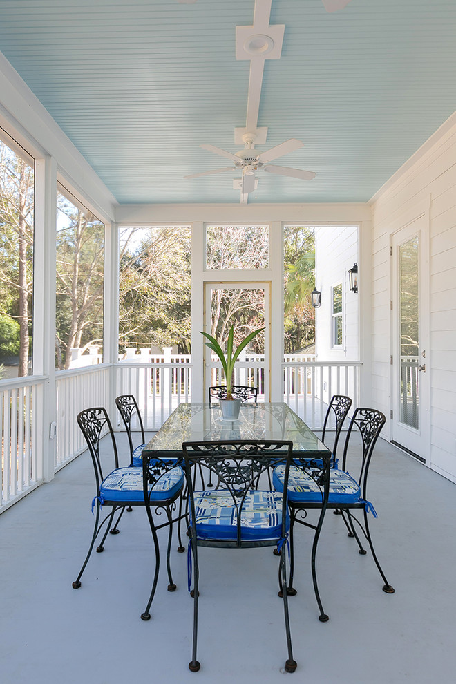 Inspiration for a mid-sized timeless screened-in front porch remodel in Charleston with decking and a roof extension