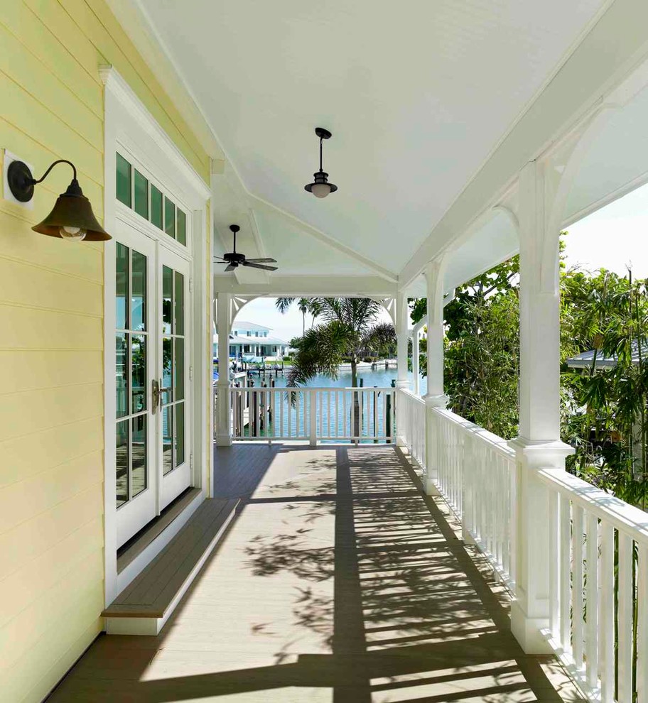 Elegant porch photo in Tampa with decking and a roof extension