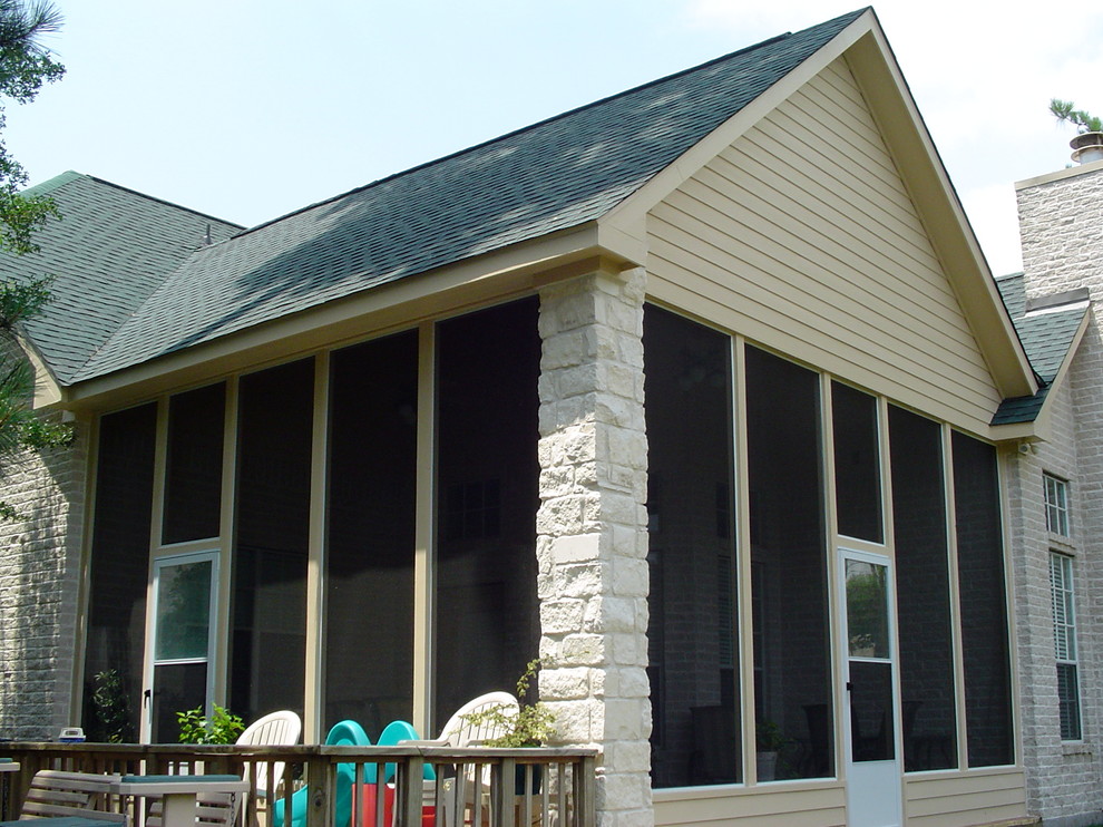 Cette image montre un porche d'entrée de maison arrière rustique de taille moyenne avec une moustiquaire, une dalle de béton et une extension de toiture.