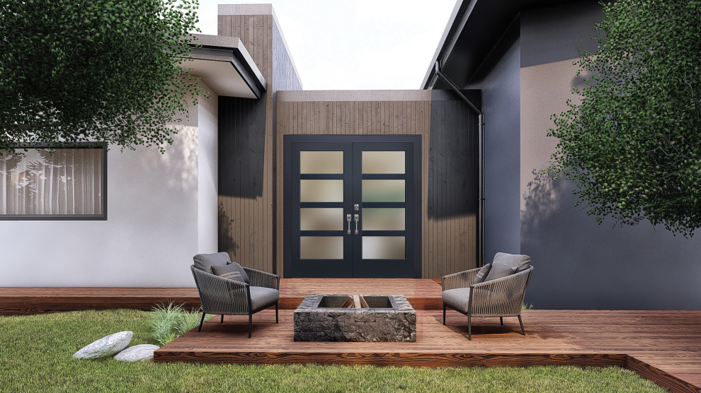 Exemple d'un grand porche d'entrée de maison arrière moderne avec une terrasse en bois.