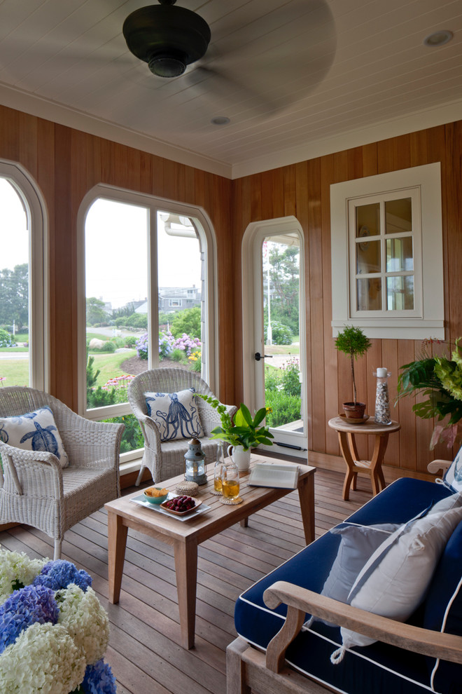 Mid-sized beach style screened-in side porch photo in Boston with decking and a roof extension