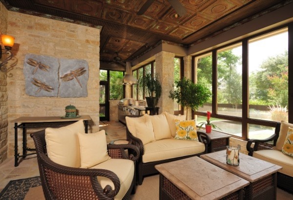 Inspiration for a large timeless stone screened-in back porch remodel in Austin with a roof extension