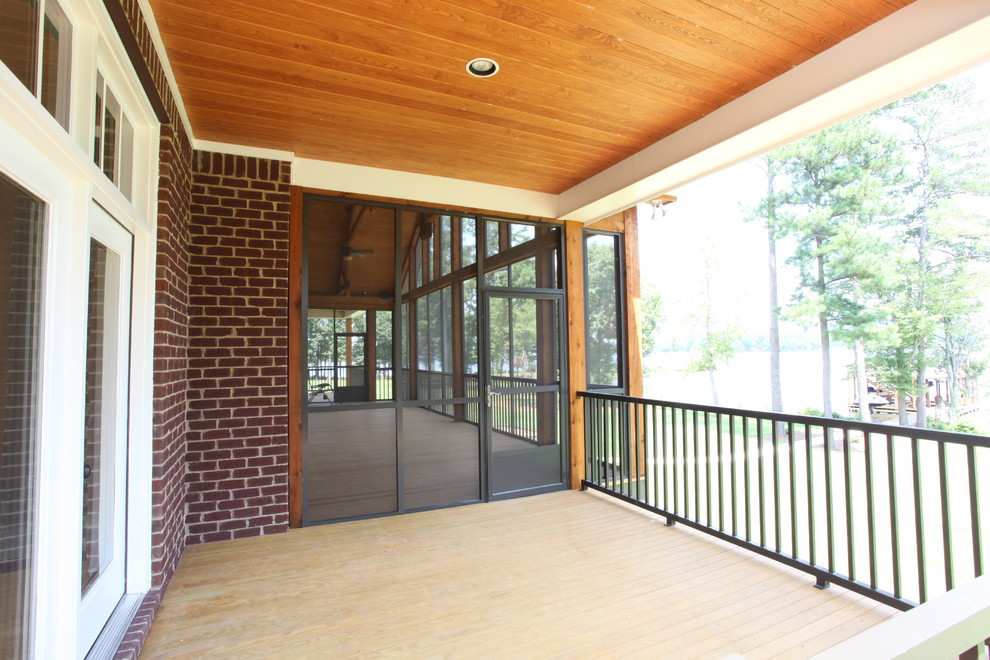 Large elegant screened-in back porch photo in Other with a roof extension