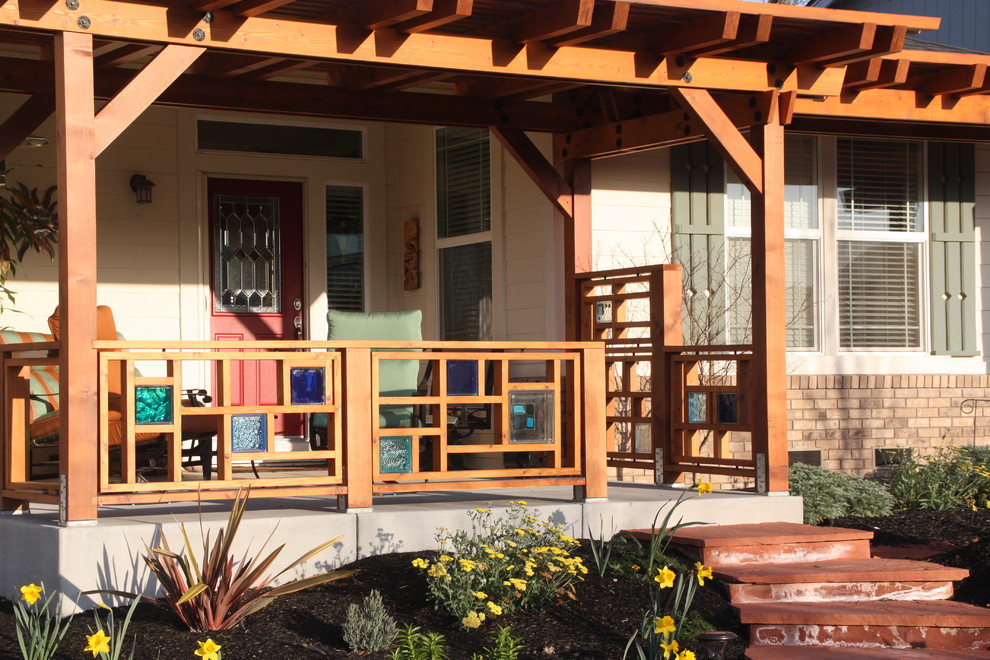 This is an example of a contemporary porch design in Cleveland with a pergola.