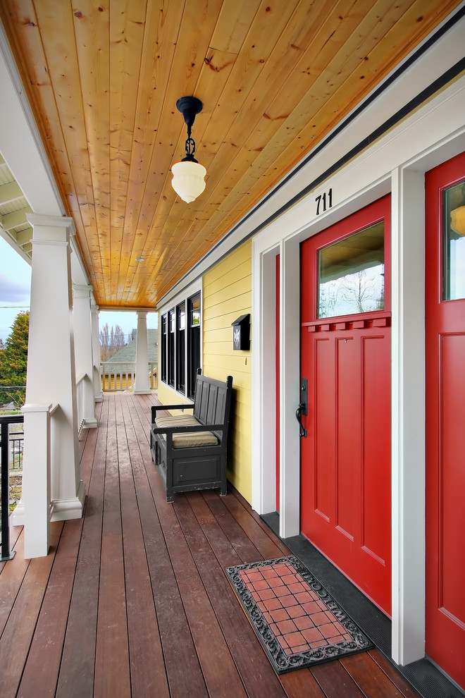 This is an example of a craftsman porch design in Seattle with decking and a roof extension.