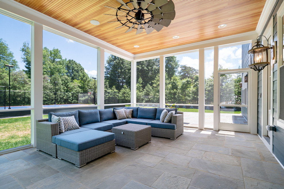 Stone screened-in back porch photo in DC Metro with a roof extension