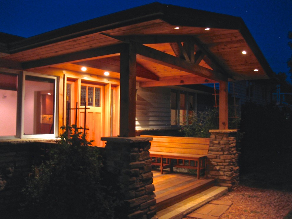 This is an example of a medium sized traditional front veranda in Denver with a roof extension.