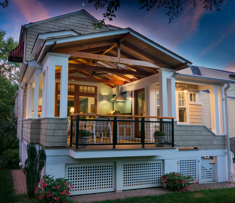 Cette photo montre un petit porche d'entrée de maison arrière tendance avec des pavés en béton, une extension de toiture et une cuisine d'été.