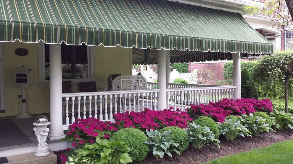 Photo of a large nautical front veranda in Philadelphia with an awning.