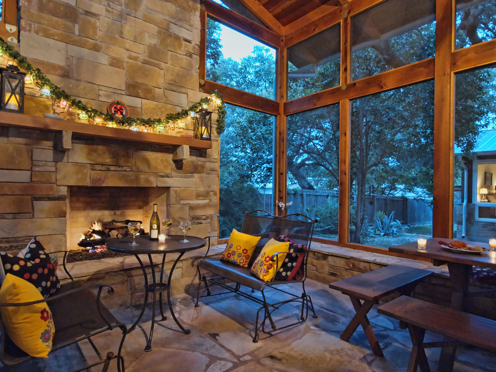 Mid-sized mountain style stone side porch photo in Austin with a roof extension