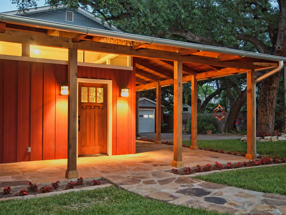 Mid-sized cottage stone side porch idea in Austin with a roof extension