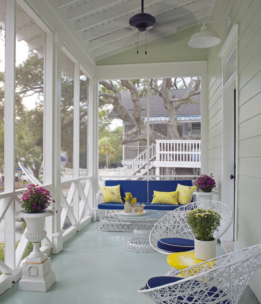 Medium sized nautical front veranda in Atlanta with concrete slabs, a roof extension and feature lighting.