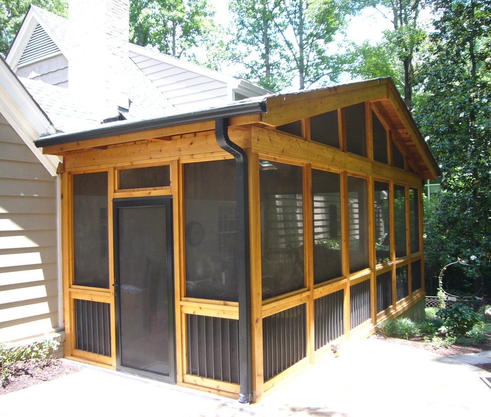 Photo of a medium sized classic back screened veranda in Atlanta.