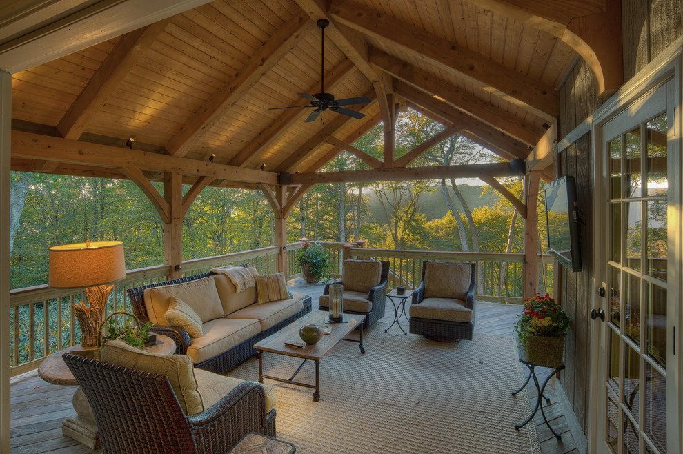 Inspiration for a mid-sized rustic side porch remodel in Charlotte with decking and a roof extension