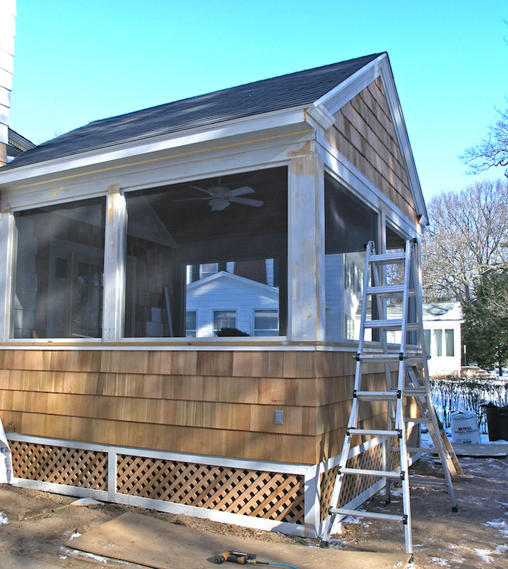 This is an example of a large classic back screened veranda in Bridgeport with decking and a roof extension.