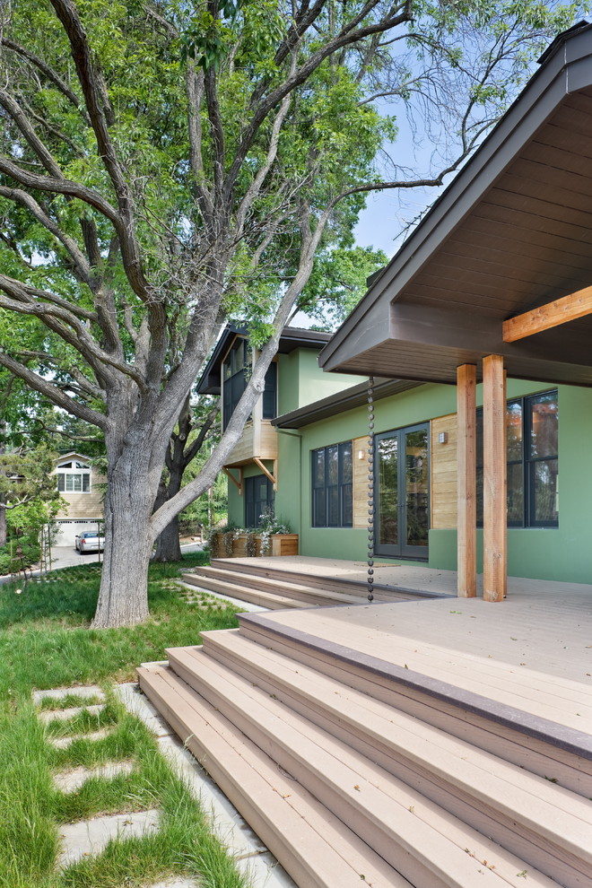 Exemple d'un porche d'entrée de maison nature avec une terrasse en bois et une extension de toiture.