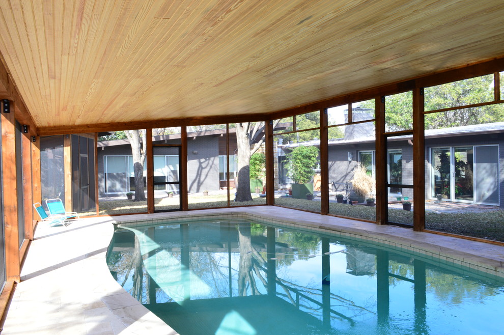 Photo of a retro back swimming pool in Dallas with tiled flooring.