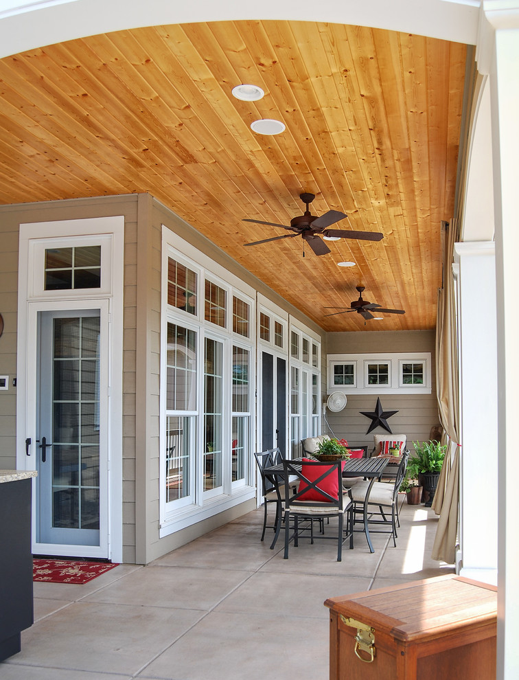 Large classic tile back porch idea in Other with a roof extension