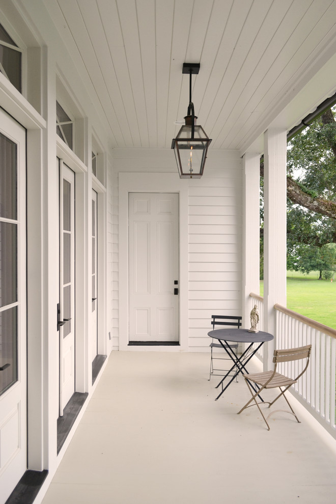 Inspiration for a classic veranda in New Orleans with decking, a roof extension and feature lighting.