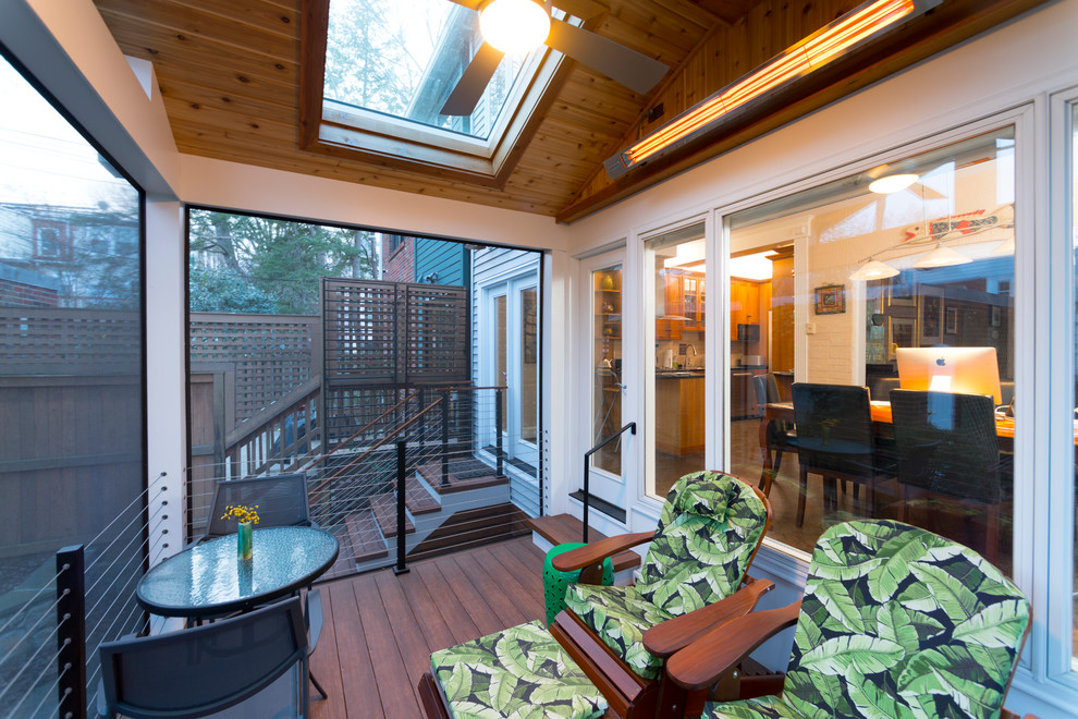 This is an example of a small modern concrete paver screened-in back porch design in DC Metro.