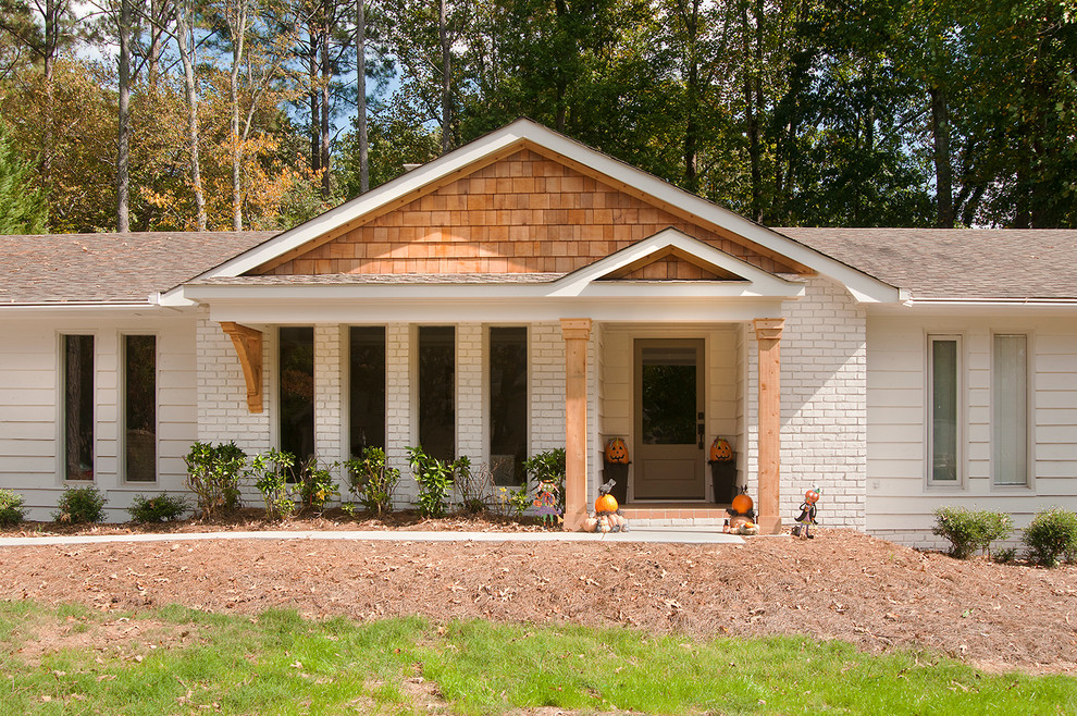 Photo of a contemporary front veranda in Atlanta with a roof extension.