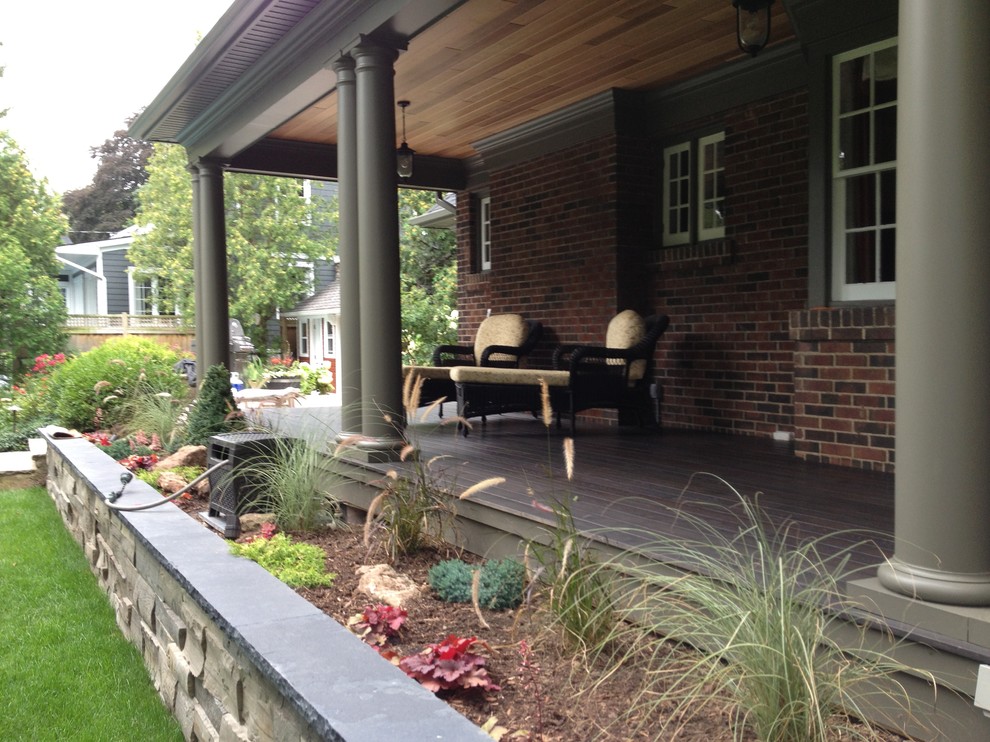 This is an example of a medium sized traditional back veranda in Burlington with decking and a roof extension.