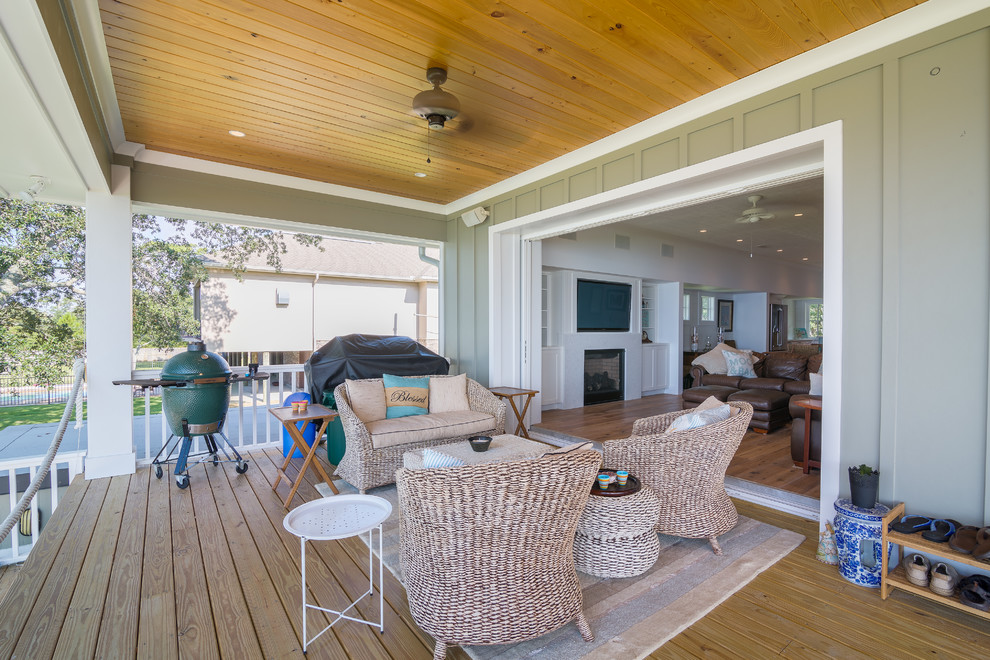 Mid-sized beach style back porch idea in Atlanta with decking and a roof extension