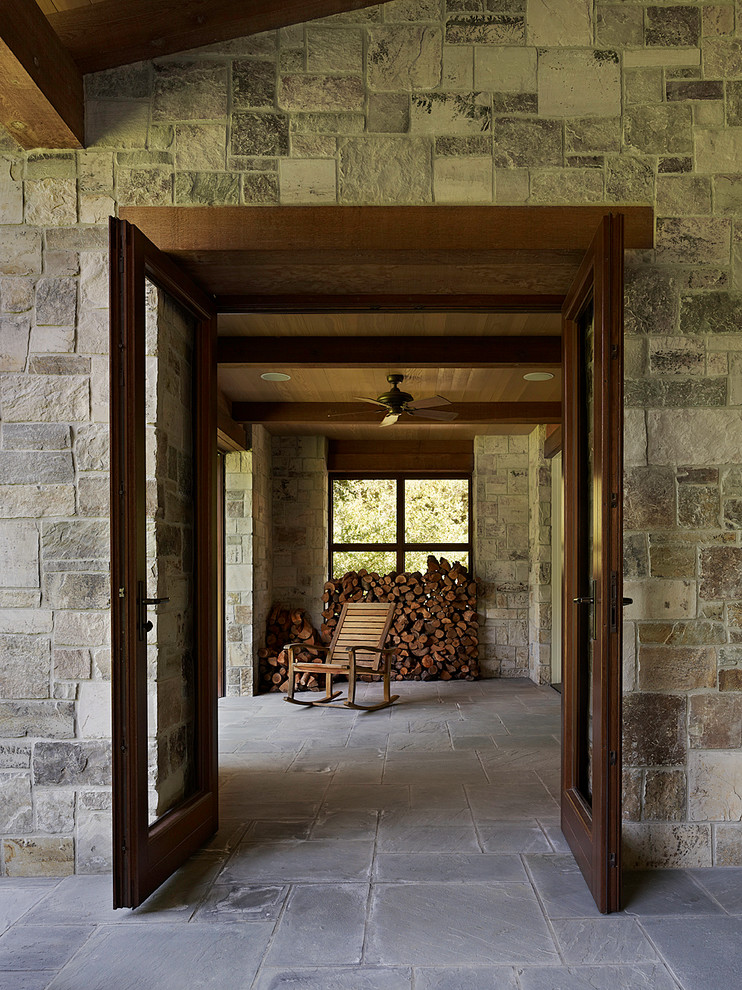 Ispirazione per un portico classico dietro casa con un tetto a sbalzo e pavimentazioni in pietra naturale