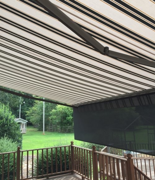 Retractable Awning Creates Shade on a Sunny Deck Transitional Porch