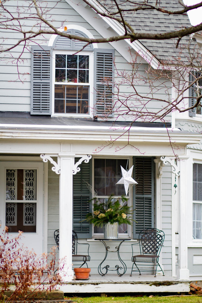 This is an example of a traditional veranda in New York with a roof extension.