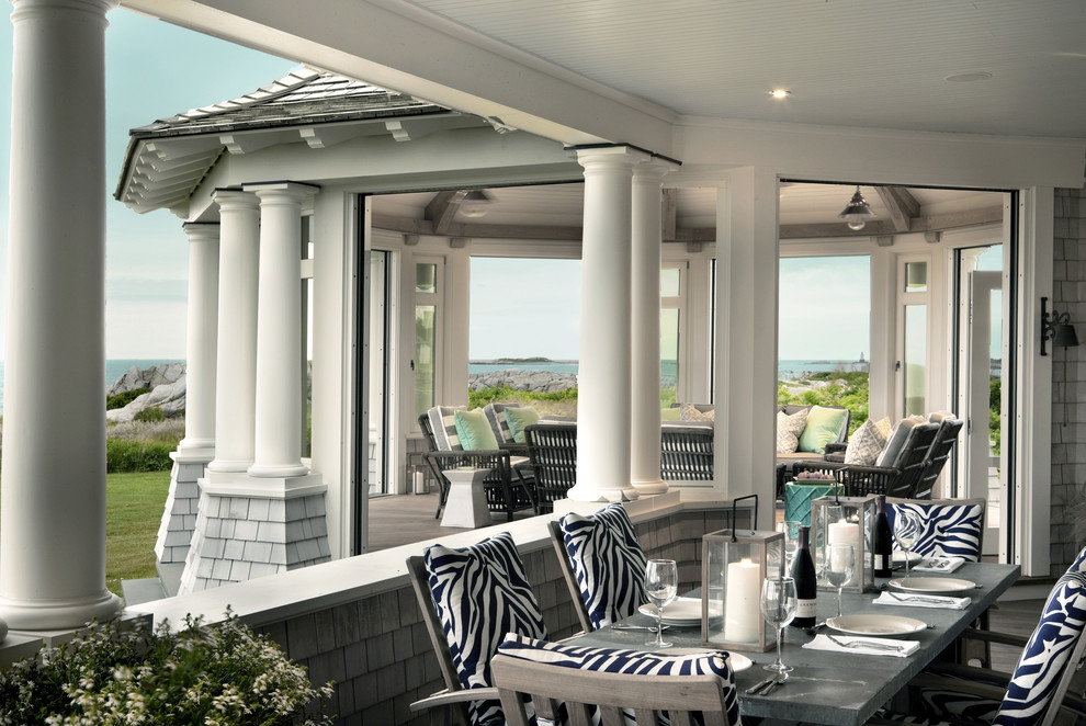 Design ideas for a large beach style back veranda in Providence with decking and a roof extension.