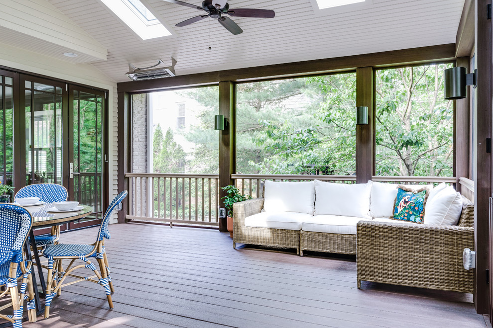 Large transitional screened-in back porch idea in Nashville with a roof extension