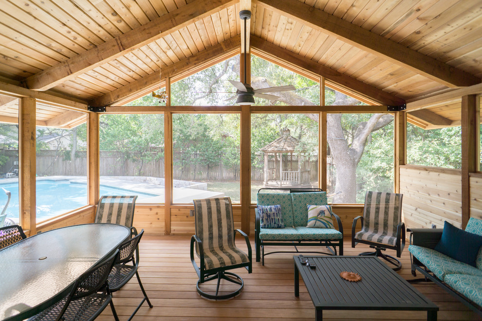 Large minimalist screened-in back porch photo in Austin with decking and a roof extension