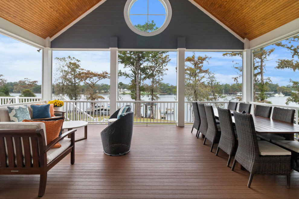 Inspiration for a large coastal back screened wood railing veranda in Raleigh with decking and a roof extension.