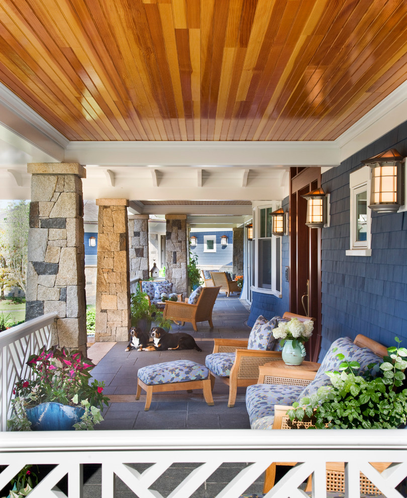 Large classic front veranda in Boston with a roof extension and tiled flooring.