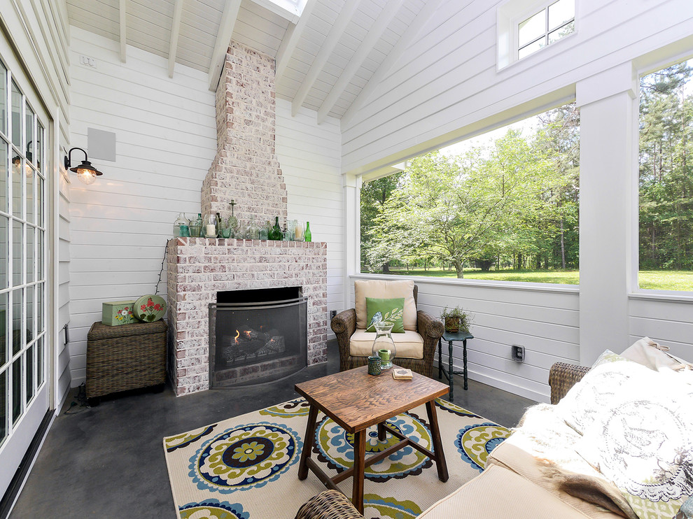Mid-sized country concrete screened-in back porch idea in Charlotte with a roof extension