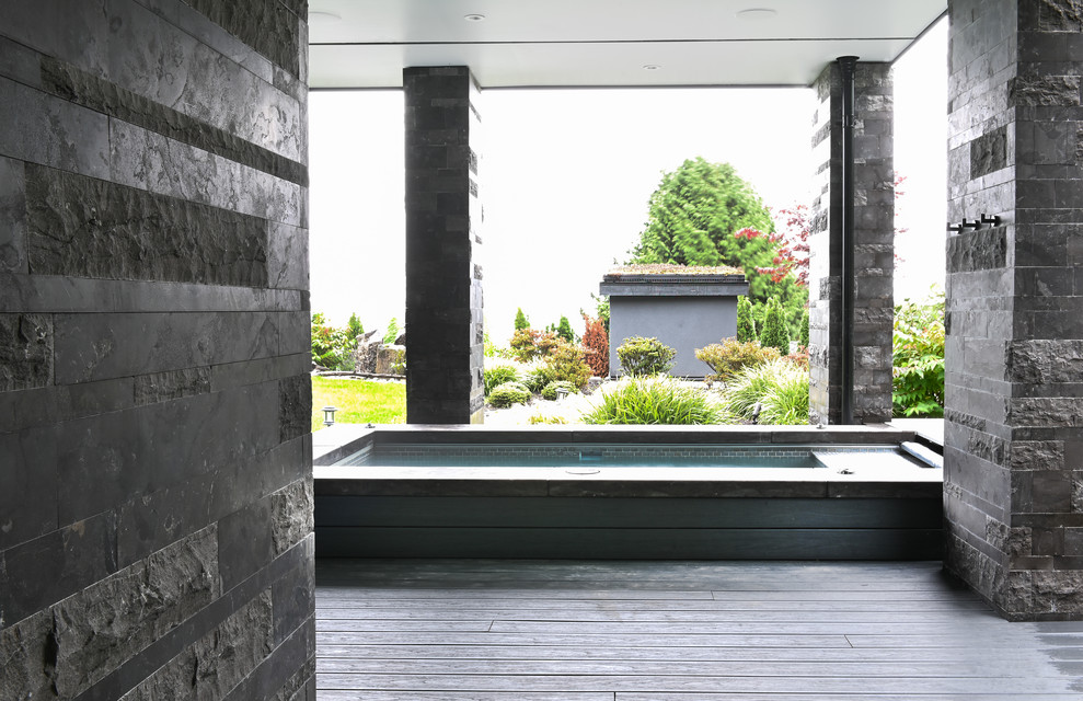 Inspiration for a large contemporary veranda in Vancouver with decking and a roof extension.