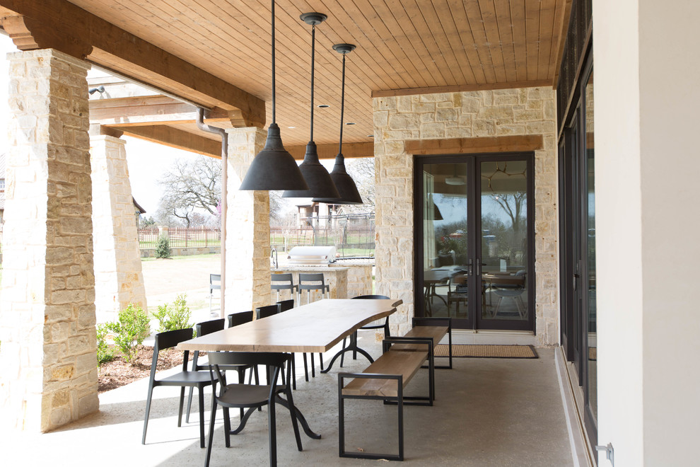 Photo of a large contemporary back veranda in Dallas with stamped concrete.