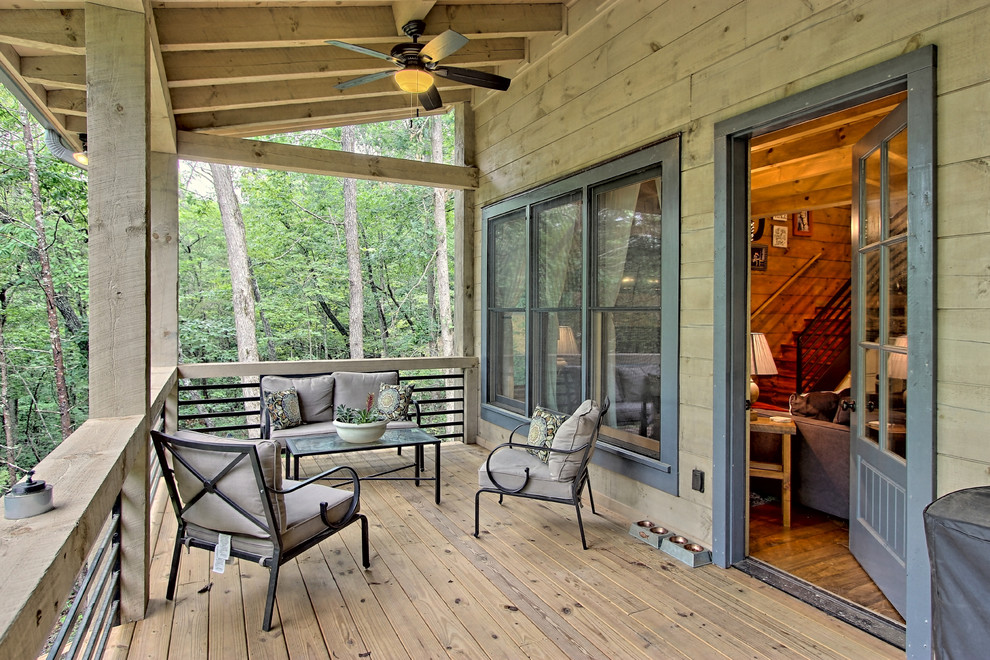 Inspiration for a small rustic front veranda in Atlanta with a roof extension.