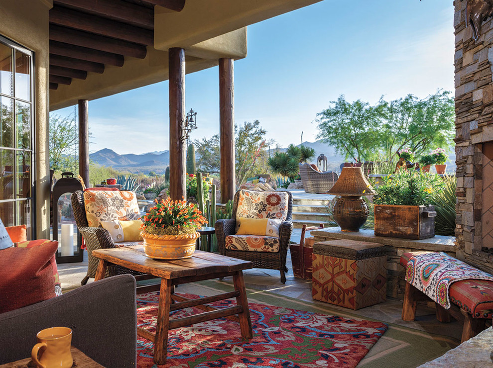 Inspiration for a veranda in Phoenix with a fireplace and a roof extension.