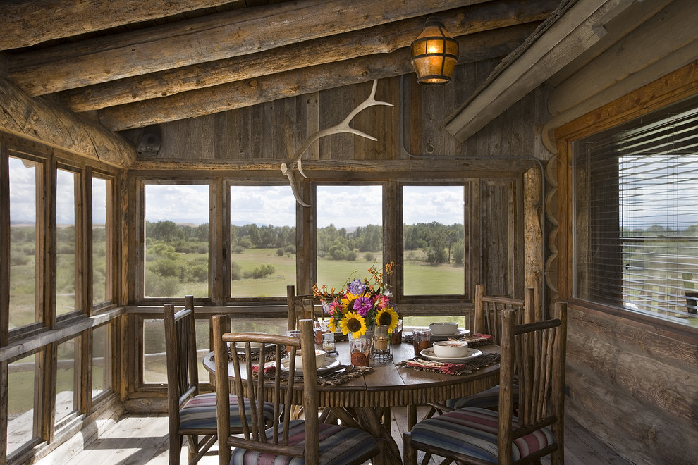 This is an example of a rustic screened veranda in Other with all types of cover.
