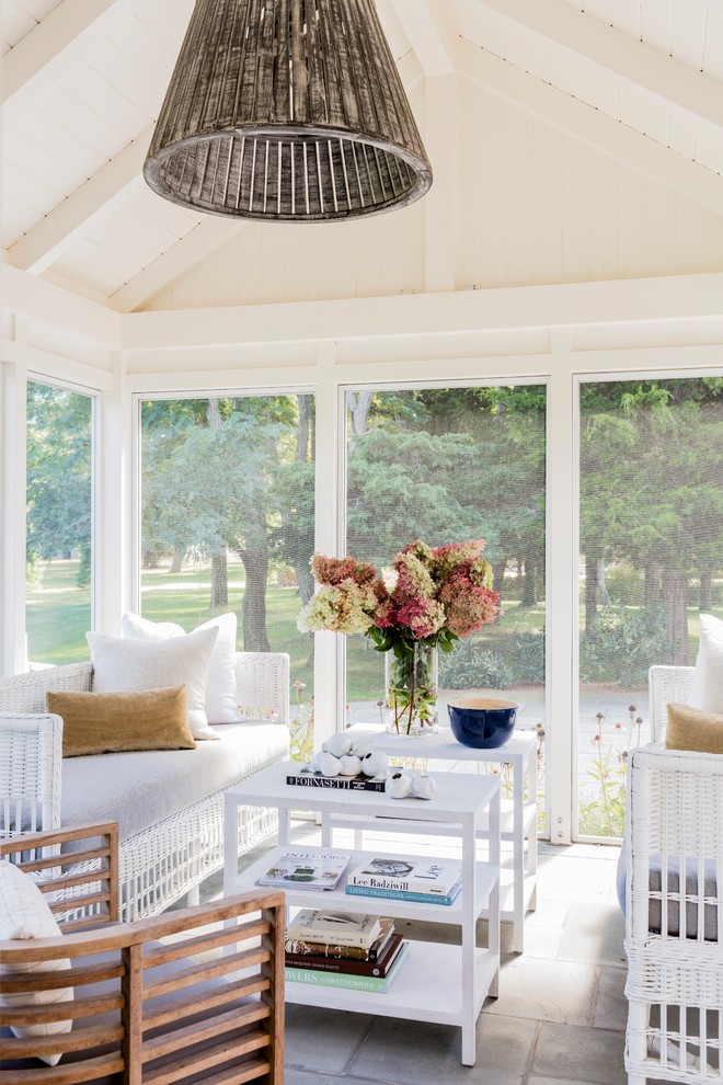 Beach style stone screened-in side porch idea in Boston with a roof extension