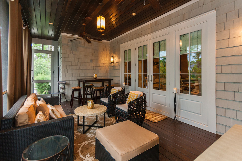 Inspiration for a large country screened-in side porch remodel in Other with a roof extension