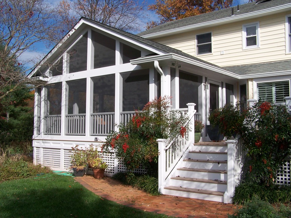 Bild på en stor vintage innätad veranda på baksidan av huset, med trädäck och takförlängning