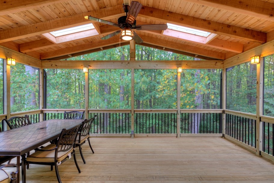 Large mountain style screened-in back porch photo in DC Metro with decking and a roof extension
